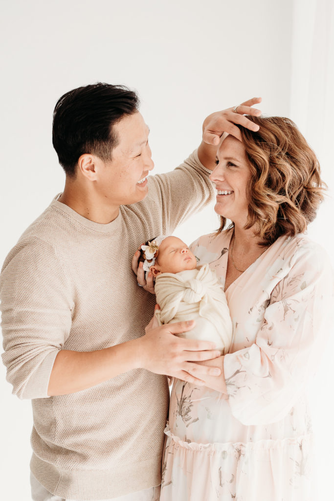new mom and dad with baby at in-studio lifestyle newborn session